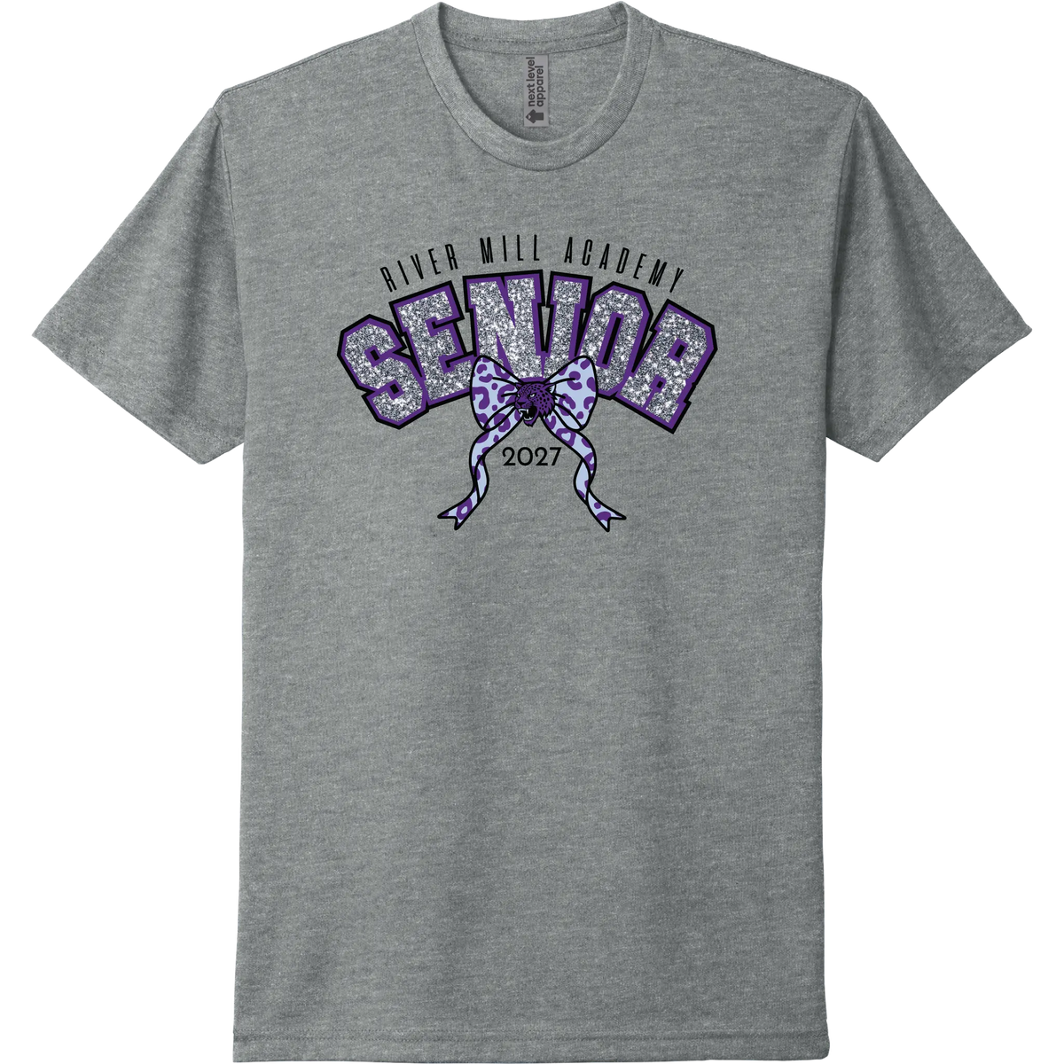 A dark heather gray short-sleeve t-shirt with a purple and glittery silver graphic on the chest reading 'River Mill Academy Senior 2027' with a bow design.